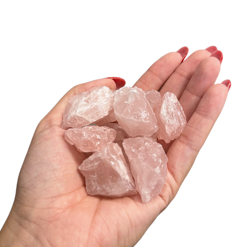 Raw unpolished pink rose quartz chunk, hand selected for heart chakra grid work, on bone background.