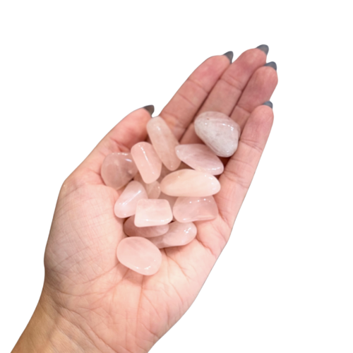 Polished pink rose quartz tumblestone, soft pink colour, hand sized for the pocket, on bone background.