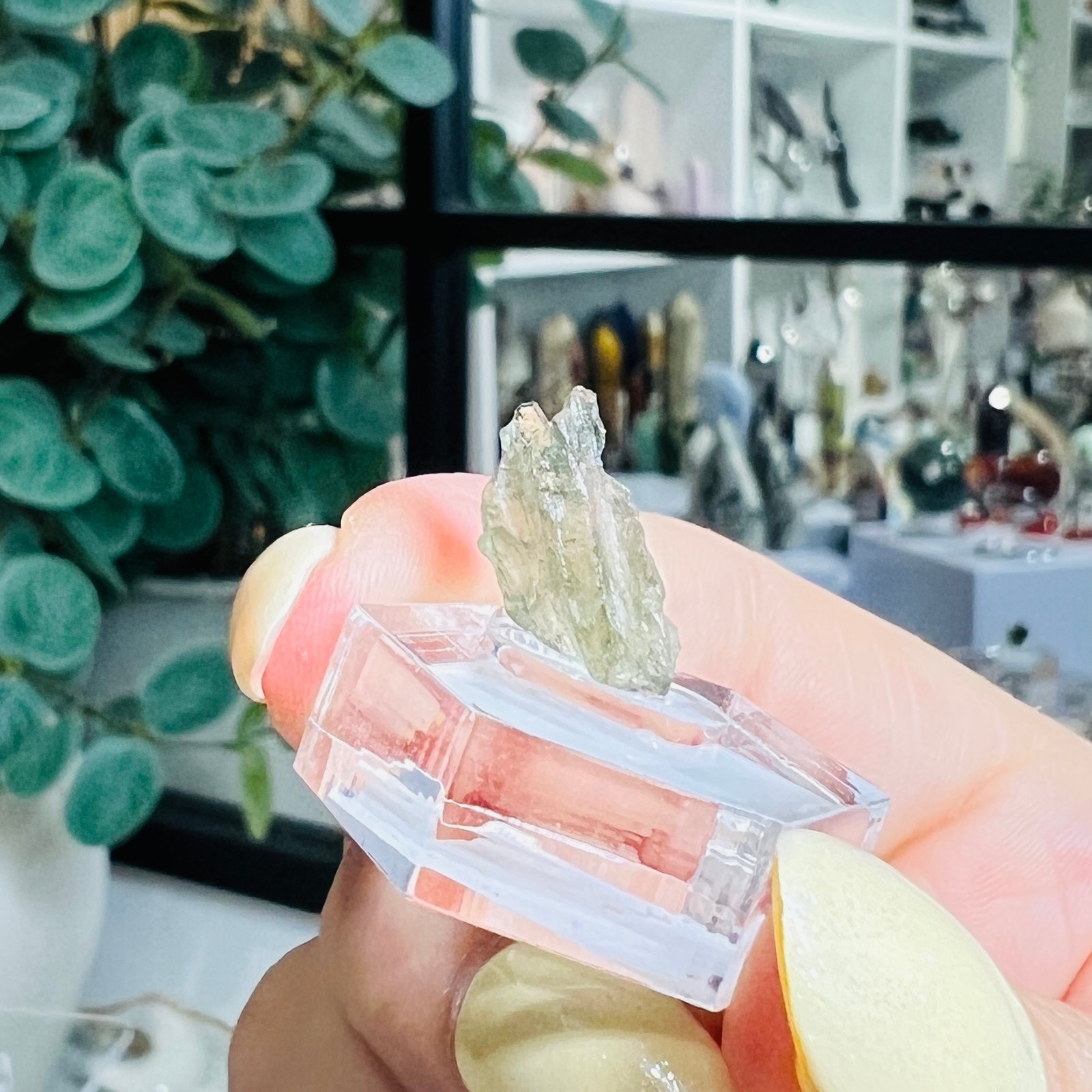 Moldavite Raw Stone 0.45g Czech Tektite C1 2 Moldavite raw stone 0.45g Czech tektite C1, pale straw green natural glass on a clear hexagonal display base, Mystic Grove UK