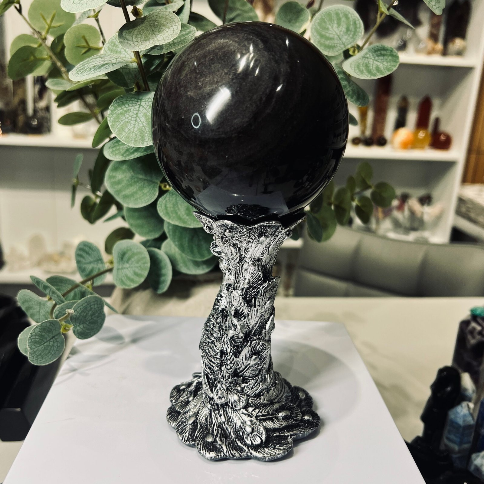 Silver Sheen Obsidian Sphere 90mm with Silver Stand 3 Silver sheen obsidian sphere close up showing the soft silver sheen across the black glass