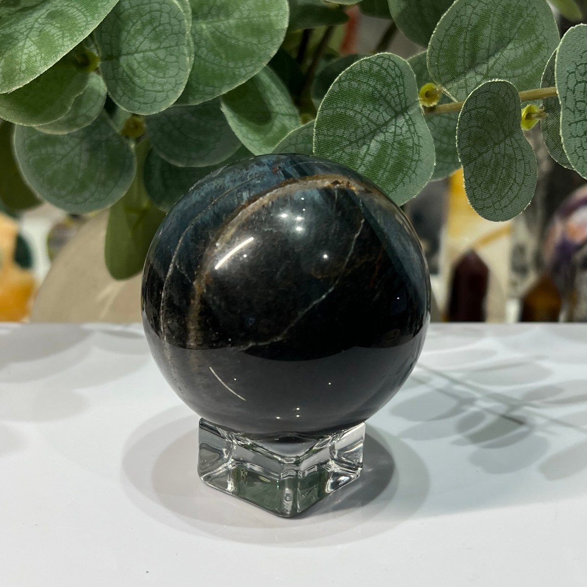 Blue tigers eye sphere showing gold chatoyant bands