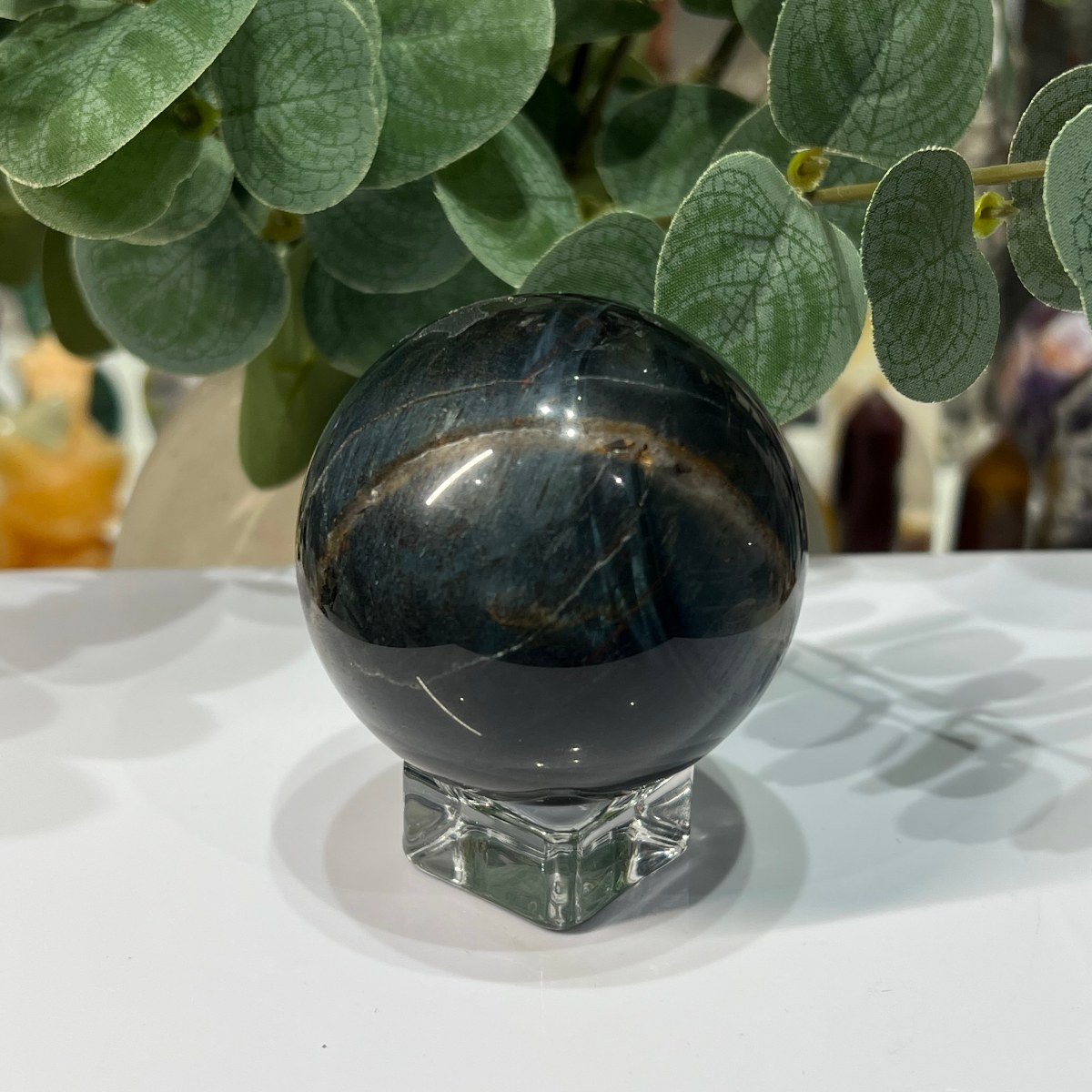 Blue tigers eye sphere side view with gold flash