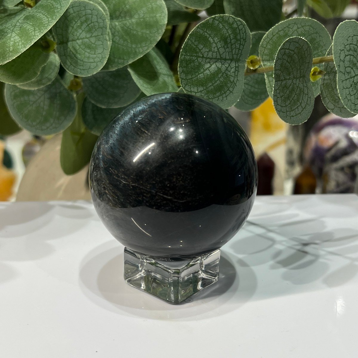 Blue tigers eye sphere on its stand