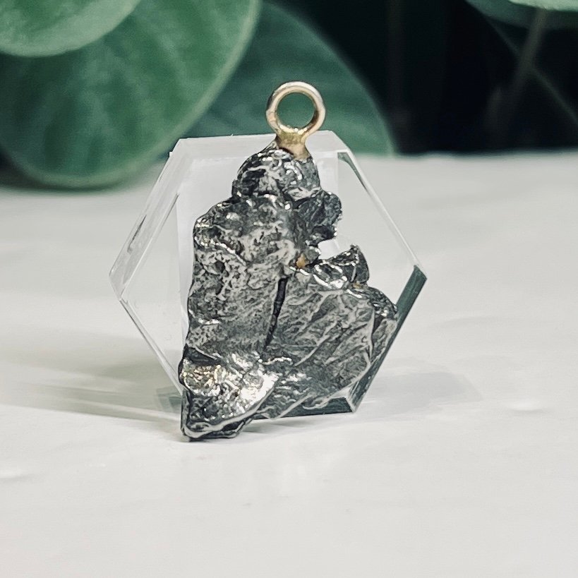 Campo del Cielo meteorite pendant set in a clear hexagon, piece A