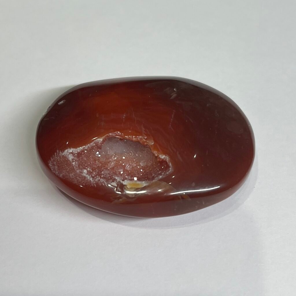 Home 2026 31 Carnelian druzy palm stone A, deep red orange with a sparkling druzy pocket