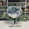 Celestite Geode on Stand 2.6kg Large celestite geode on a black metal and clear acrylic stand, sky blue crystals, Mystic Grove UK