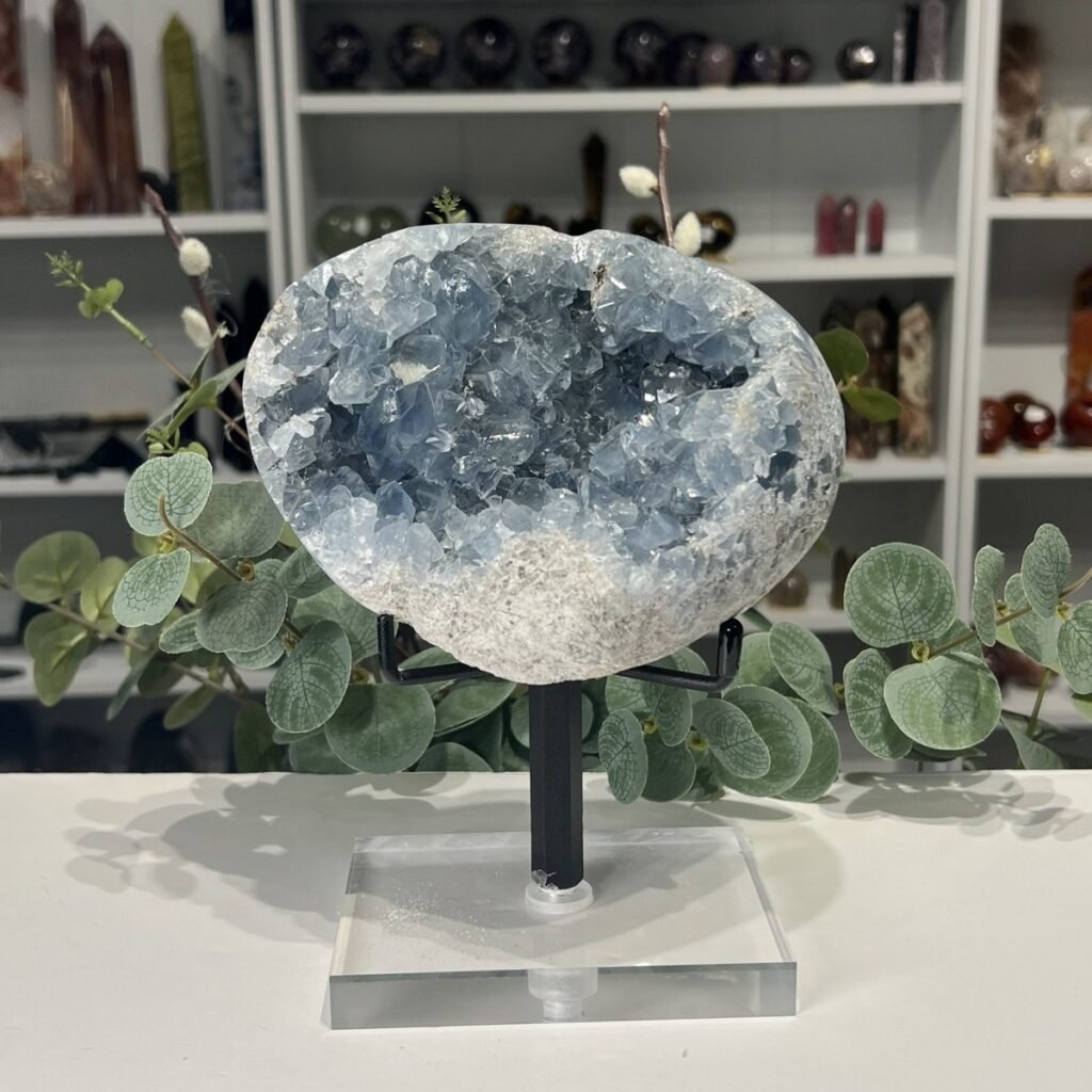 Large celestite geode on a black metal and clear acrylic stand, sky blue crystals, Mystic Grove UK