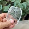 Clear selenite rounded plate held in the hand