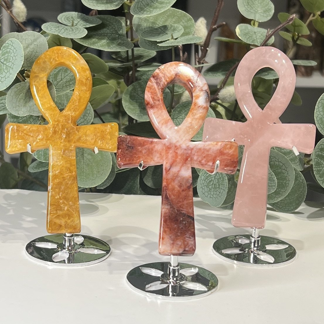 Crystal Ankh on Stand 13cm Crystal ankh carvings 13cm on silver stands in golden healer, fire quartz and rose quartz, Mystic Grove UK