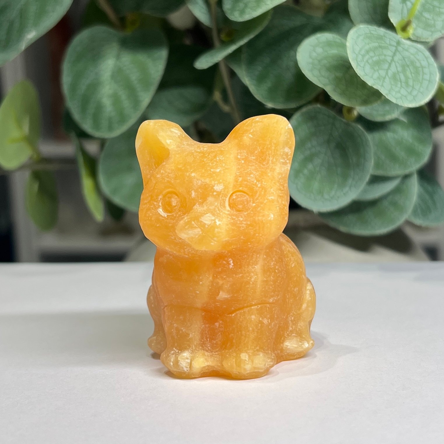 crystal cat carving orange calcite Orange calcite crystal cat carving 6cm, warm tangerine with banding