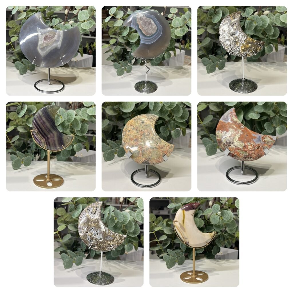 Eight crystal moon carvings on stands: agate druzy, ocean jasper, fluorite, crazy lace agate, money agate and mookaite