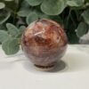 Hematoid quartz sphere B, 69mm, red veining through clear quartz