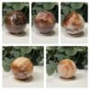 Hematoid quartz spheres A to E on wooden stands