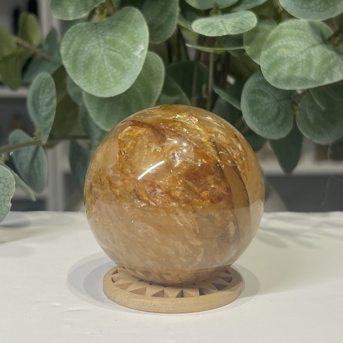 Golden Healer Quartz Sphere 63mm 1 Golden healer quartz sphere 63mm on wooden stand, view 1