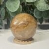 Golden Healer Quartz Sphere 63mm 3 Golden healer quartz sphere 63mm on wooden stand, view 3