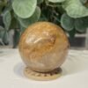 Golden Healer Quartz Sphere 63mm 4 Golden healer quartz sphere 63mm on wooden stand, view 4