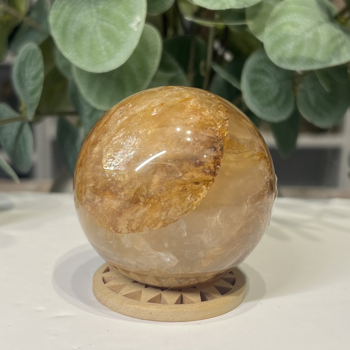 Golden Healer Quartz Sphere 63mm 4 Golden healer quartz sphere 63mm on wooden stand, view 4