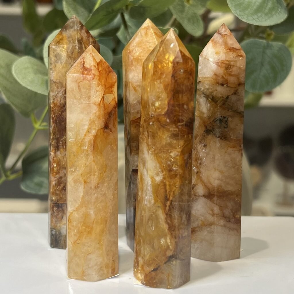 Home 2026 34 Golden healer quartz towers, a group of polished pieces together