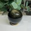 Gold sheen obsidian sphere B, 62mm, with swirling arcs of golden sheen Gold sheen obsidian sphere B, 62mm, with swirling arcs of golden sheen