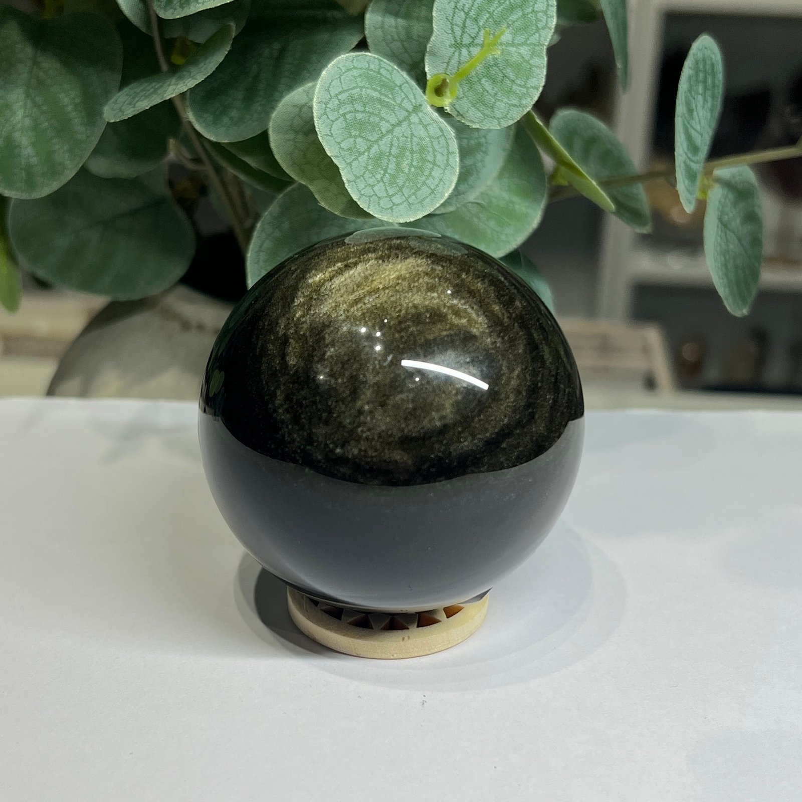 Gold sheen obsidian sphere B, 62mm, with swirling arcs of golden sheen Gold sheen obsidian sphere B, 62mm, with swirling arcs of golden sheen