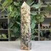 Specularite quartz tower 20cm side view with honey toned quartz and dark specularite streaks Specularite quartz tower 20cm side view with honey toned quartz and dark specularite streaks