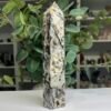 Specularite quartz tower 20cm angled view showing sparkling quartz pockets Specularite quartz tower 20cm angled view showing sparkling quartz pockets