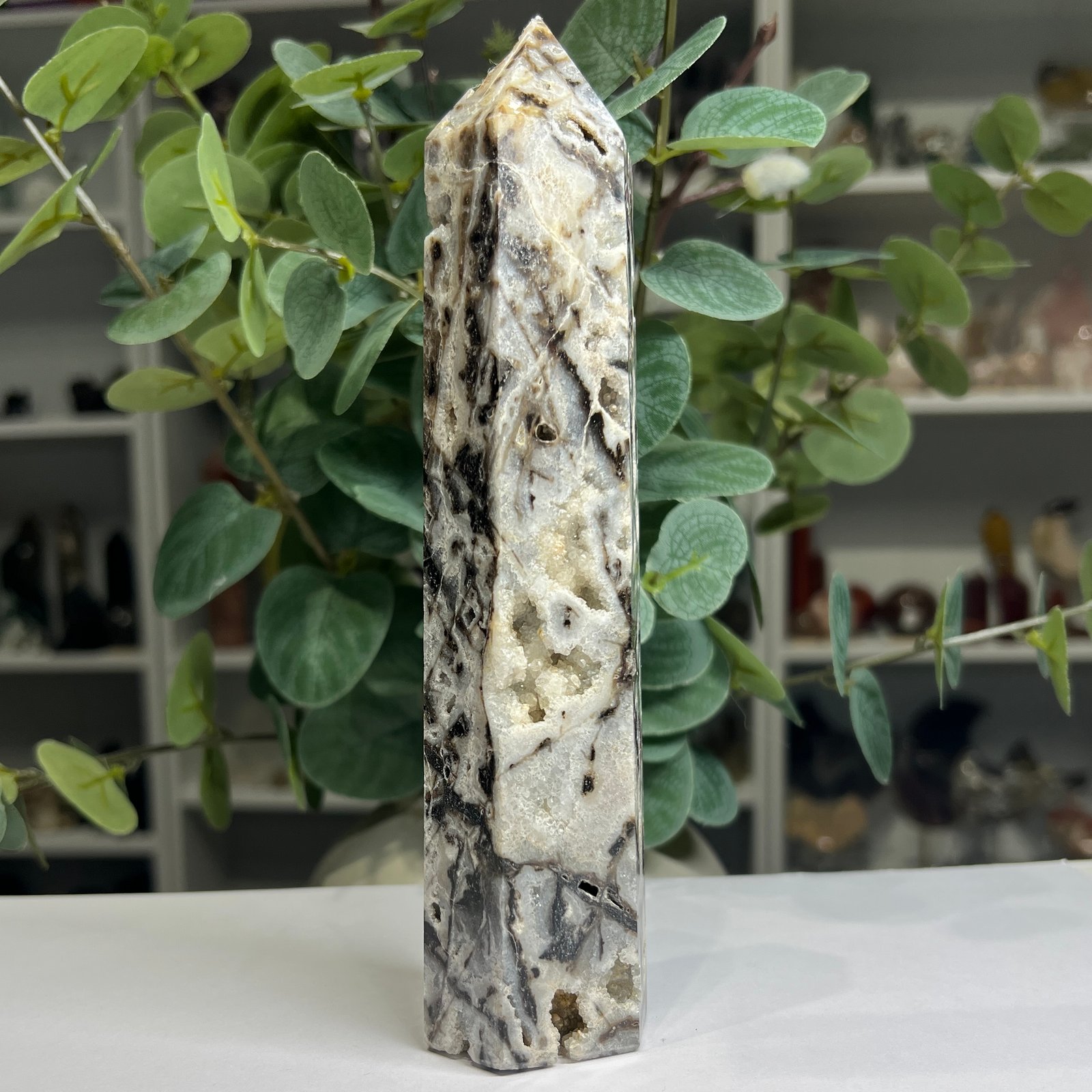 Specularite quartz tower 20cm angled view showing sparkling quartz pockets Specularite quartz tower 20cm angled view showing sparkling quartz pockets