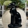 Black obsidian Bastet statue 10cm side view showing carved collar and seated pose Black obsidian Bastet statue 10cm side view showing carved collar and seated pose