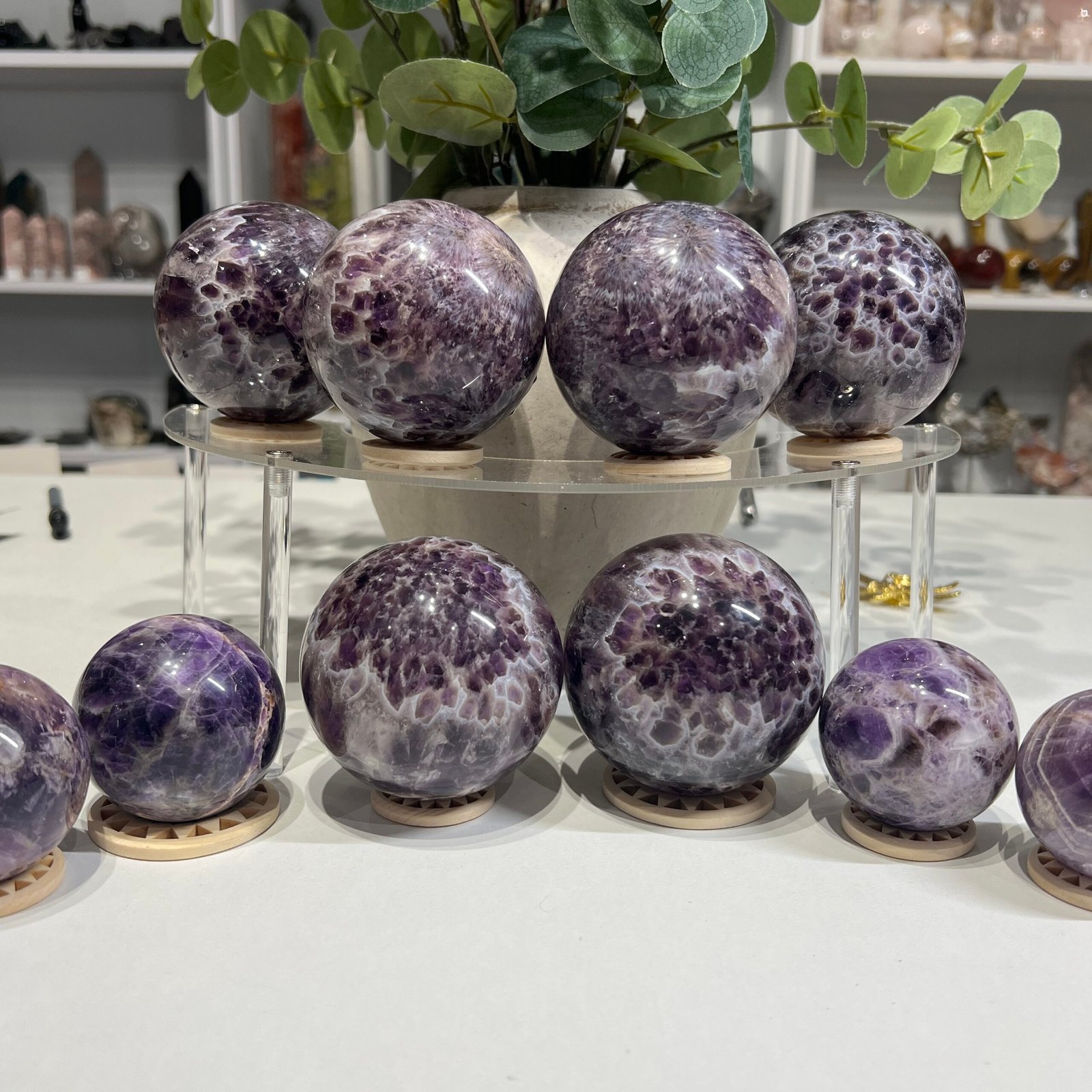 Dream amethyst spheres group, chevron amethyst crystal balls on wooden stands Dream amethyst spheres group, chevron amethyst crystal balls on wooden stands