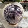 Dream amethyst sphere F 69mm with white chevrons Dream amethyst sphere F 69mm with white chevrons