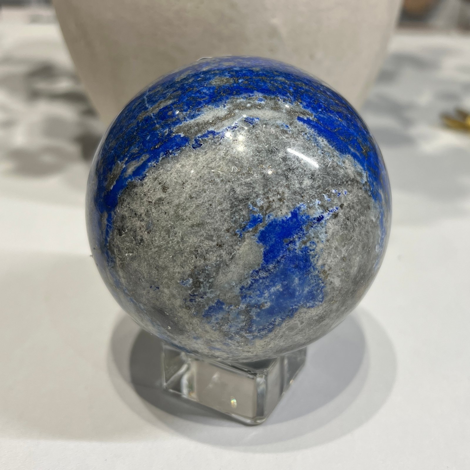Lapis lazuli sphere A 80mm with bright blue patch and pyrite flecks Lapis lazuli sphere A 80mm with bright blue patch and pyrite flecks