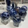 Sodalite spheres group on clear stands Sodalite spheres group on clear stands, deep blue with white and orange veining