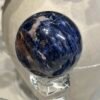 Sodalite sphere A 55mm, deep blue with rust and orange bands Sodalite sphere A 55mm, deep blue with rust and orange bands