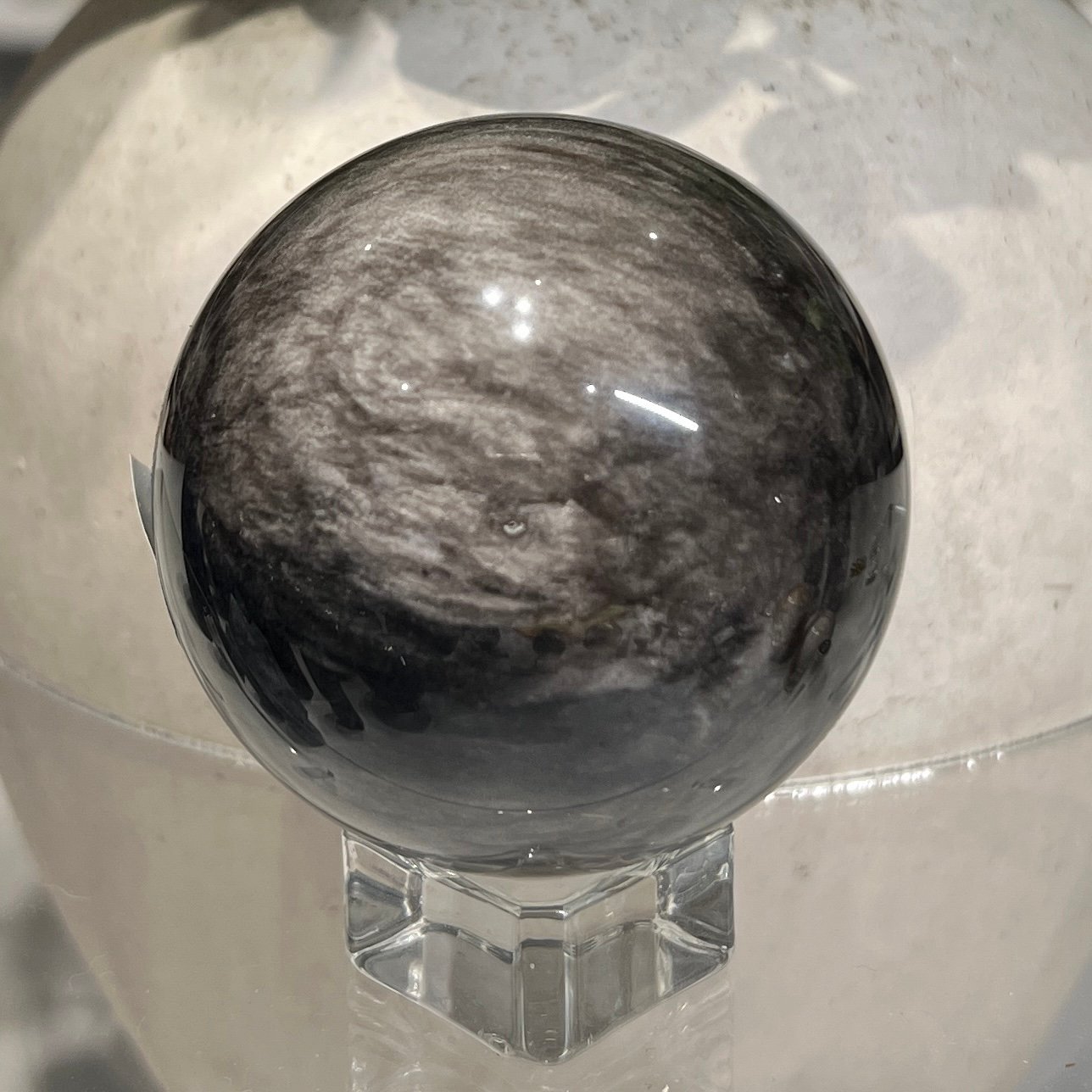Silver sheen obsidian sphere G 58mm with swirling silver sheen Silver sheen obsidian sphere G 58mm with swirling silver sheen