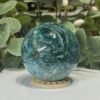 Blue apatite sphere showing pale swirls and fine veins through the blue