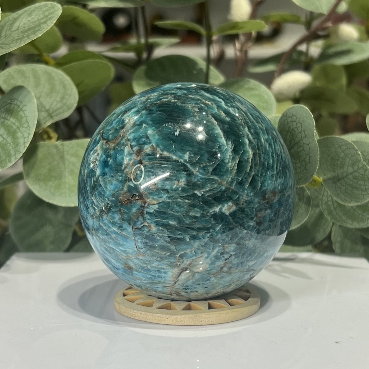 Blue apatite sphere showing pale swirls and fine veins through the blue