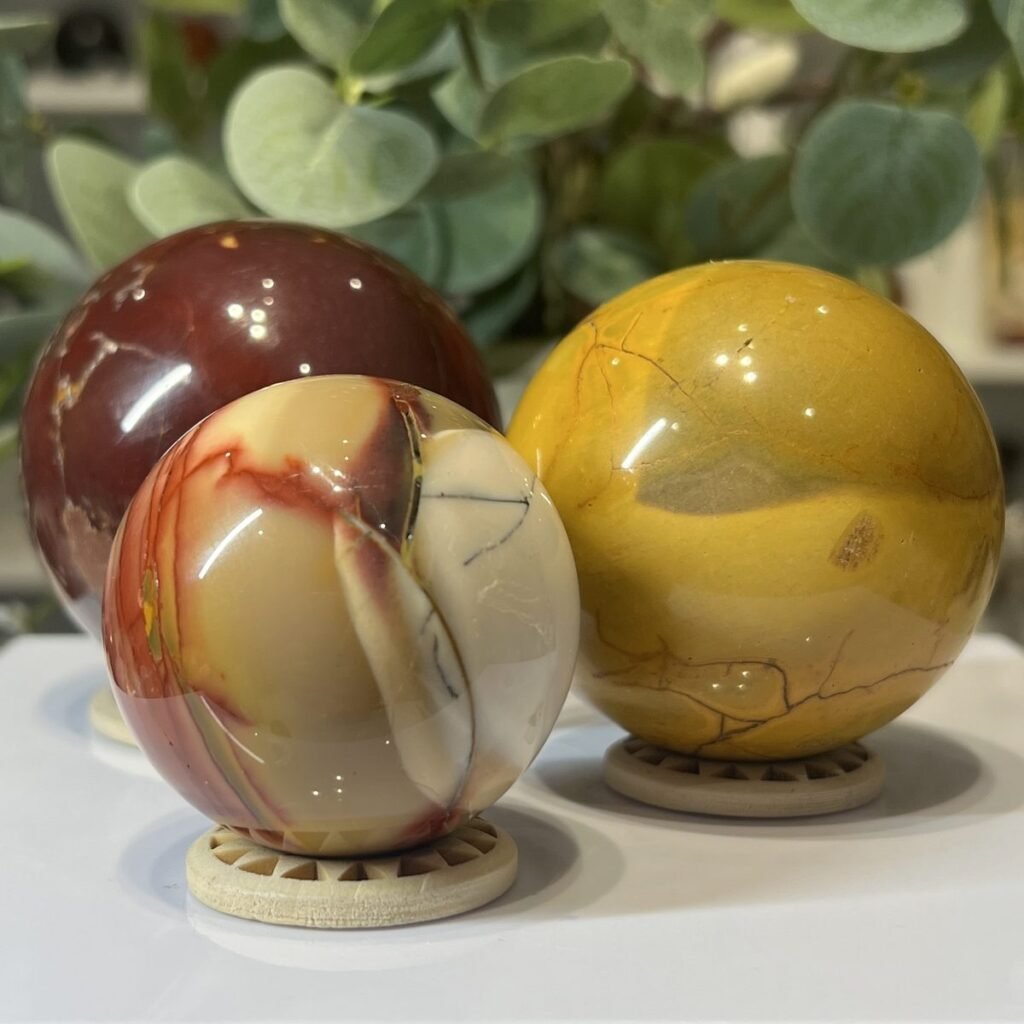 Home 2026 38 Mookaite spheres, a group of polished pieces together