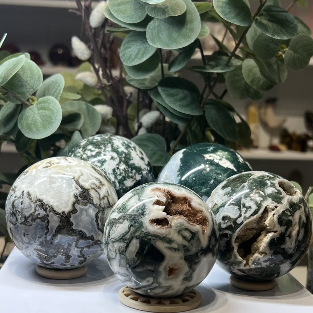 Home 2026 36 Five moss agate spheres on wooden stands