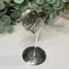 Pyrite heart on silver zodiac stand from above Pyrite heart on silver zodiac stand from above