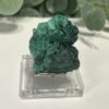 Raw Malachite on Stand 4.5cm to 7cm Raw malachite close view of the soft radiating green fibres