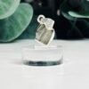 Raw moldavite C1 0.45g Czech tektite from the Chlum sand mine on a clear stand