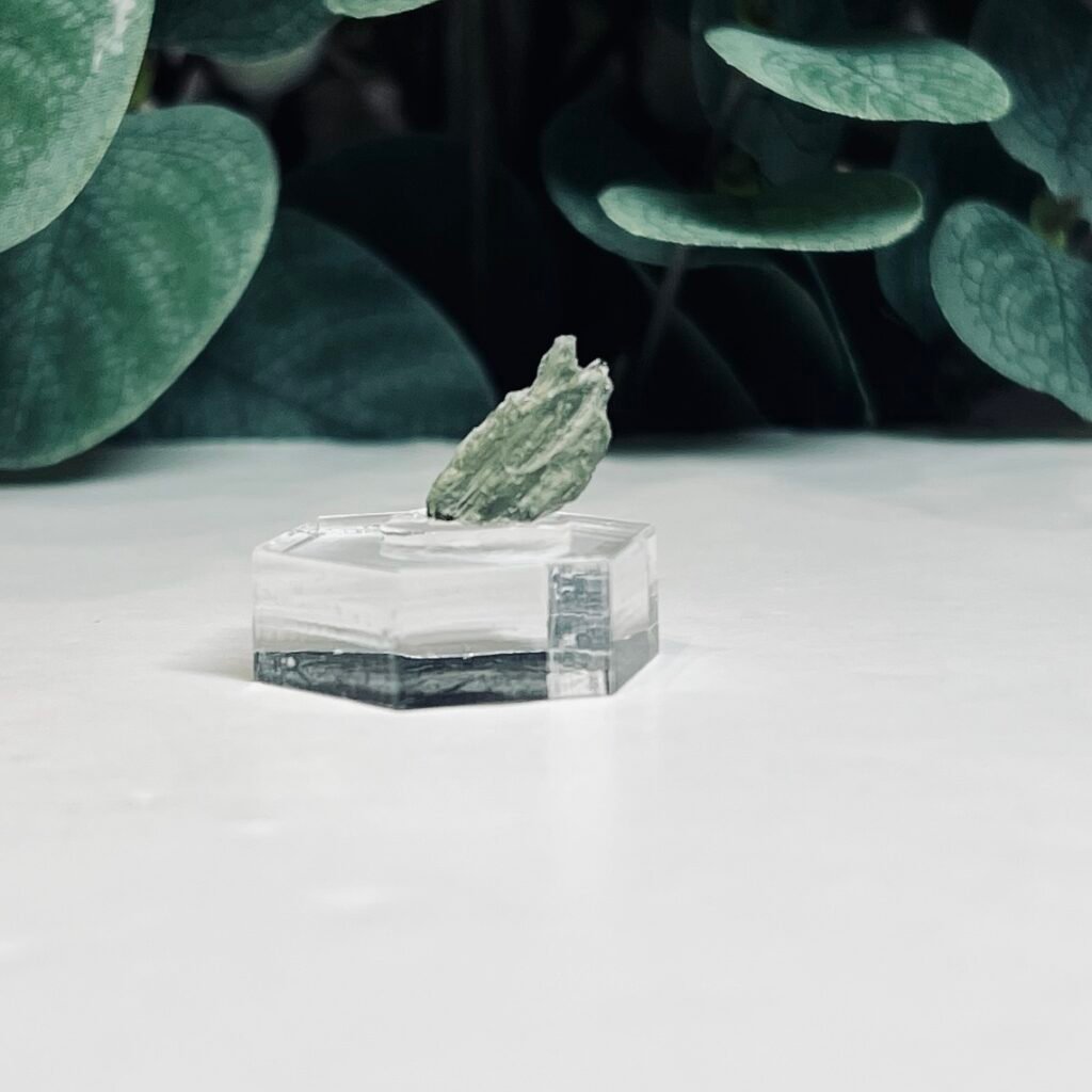 Seven pieces of genuine raw Czech moldavite on clear stands