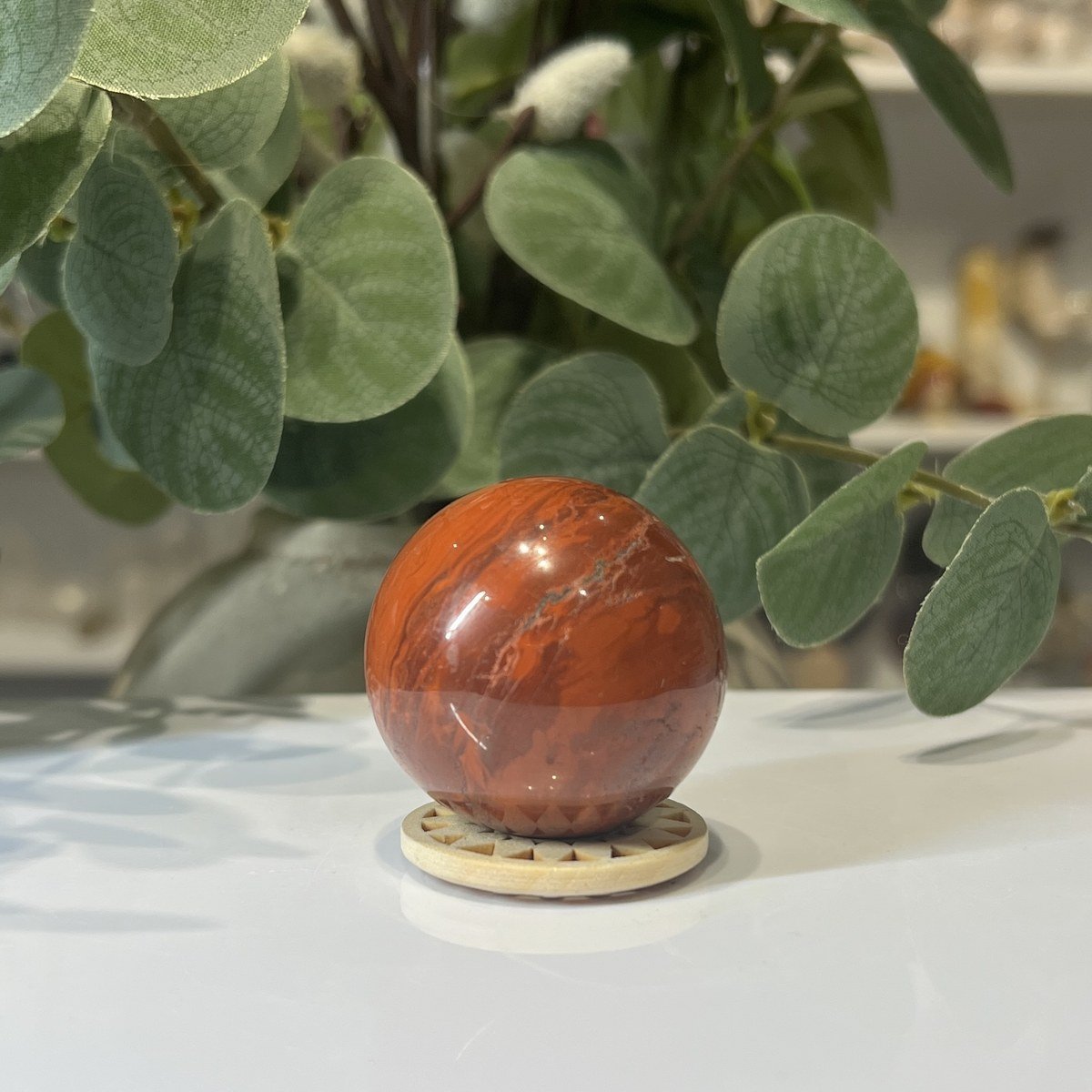 Red jasper sphere B Red jasper sphere B, 40mm, deep red with lighter veins, on a wooden stand