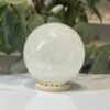 Snow quartz sphere A Snow quartz sphere A, 70mm, milky white, on a wooden stand