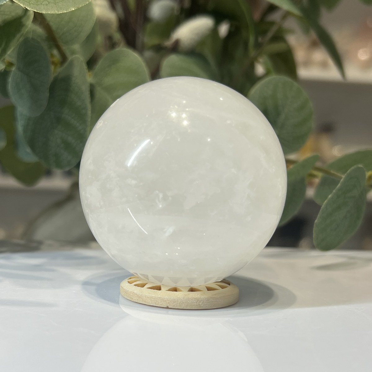 Snow quartz sphere A Snow quartz sphere A, 70mm, milky white, on a wooden stand