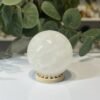 Snow quartz sphere B Snow quartz sphere B, 52mm, milky white, on a wooden stand