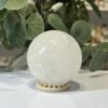 Snow quartz sphere C Snow quartz sphere C, 70mm, milky white, on a wooden stand
