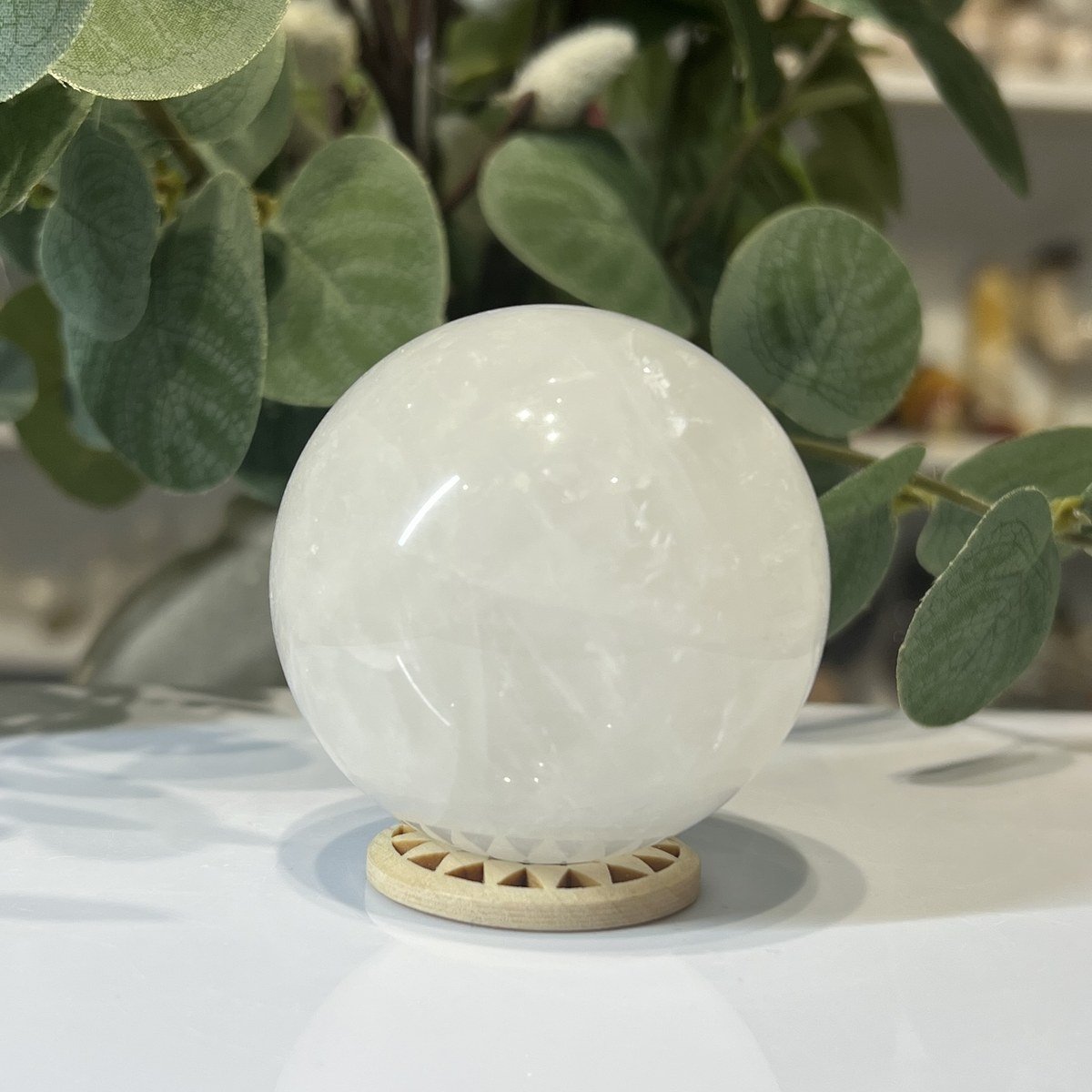 Snow quartz sphere C Snow quartz sphere C, 70mm, milky white, on a wooden stand