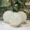 Three snow quartz spheres on wooden stands Three snow quartz spheres on wooden stands