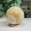 sunstone sphere 6cm Sunstone sphere 6cm, cream feldspar with peach sunstone and golden veining, on a wooden sphere stand